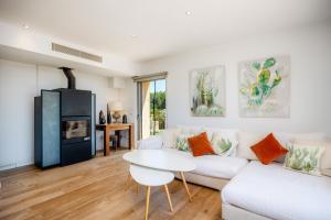 a living room with a white couch and a table at Finca Son Montserrat in Llucmajor