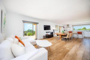a living room with a white couch and a table at Finca Son Montserrat in Llucmajor