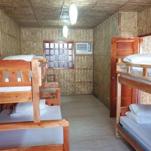 a room with a bunch of bunk beds in it at Beachhouse for 15 pax with pavilion in Nasugbu