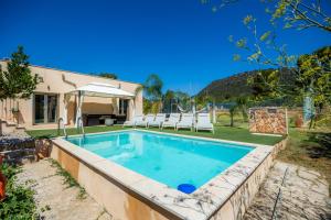 a swimming pool in the backyard of a house at Finca Son Montserrat in Llucmajor