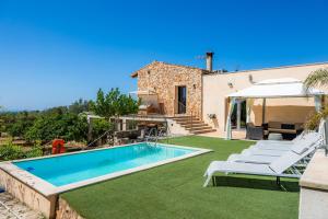 a villa with a swimming pool and lawn at Finca Son Montserrat in Llucmajor