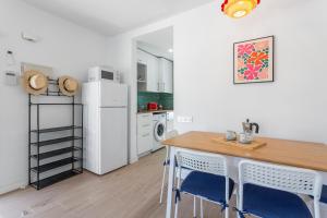 a kitchen with a table and chairs and a refrigerator at Brisa Azul in Corralejo