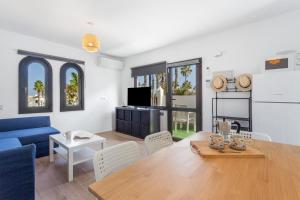 a living room with a blue couch and a table at Brisa Azul in Corralejo