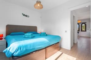 a bedroom with a large bed with blue sheets at Brisa Azul in Corralejo +25 photos