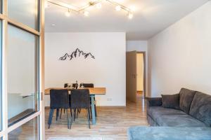 a living room with a table and a couch at Fewo Maria Grasegger in Grainau