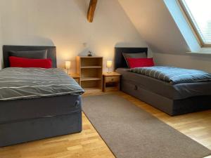 a attic bedroom with two beds and a couch at Monteurwohnung Schulze in Bad Bodenteich