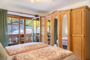 a bedroom with a bed and a large window at Fewo Maria Grasegger in Grainau