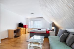 a living room with a couch and a bed at Monteurwohnung Schulze in Bad Bodenteich
