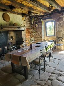 a dining room with a large table and chairs at Maison de Vacances Chadirac in Auriac