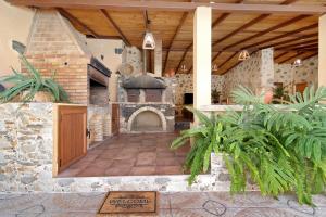 an outdoor patio with a fireplace in a building at Casa Las Toscas in Ingenio