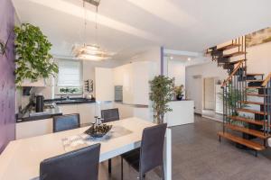 a kitchen and dining room with a table and chairs at Luxury Lakefront Maisonette in Lezzeno