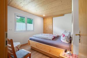 a bed in a small room with a window at Ferienwohnung Blösling 2 in Bernau im Schwarzwald