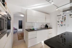 a white kitchen with white cabinets and a sink at Feriendomizil Berta Benzingen 1 in Winterlingen