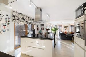 a kitchen with a counter top and a living room at Feriendomizil Berta Benzingen 1 in Winterlingen