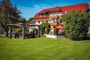 a hotel with a green lawn in front of a building at Ferienhaus Bührer in Freiamt