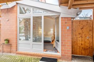 a sliding glass door with a bedroom in the background at room4you in Hemmingen