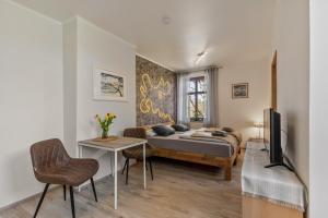 a bedroom with a bed and a table and a tv at Ferienwohnung Klosterheide in Lindow