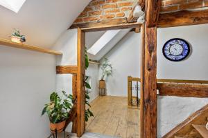 an attic hallway with a clock on the wall at Ferienwohnung Klosterheide in Lindow