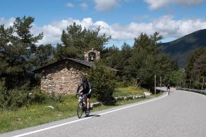 a man riding a bike down a road at Hotel Màgic La Massana by Nexta in La Massana