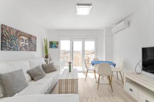 a white living room with a white couch and a table at Antogil-mata1 in La Mata