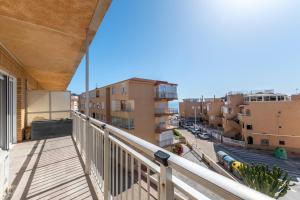 a balcony with a view of a street and buildings at Antogil-mata1 in La Mata
