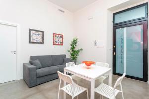 a living room with a couch and a table and chairs at Taormina Center Suite with Jacuzzi in Taormina +15 photos