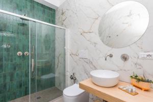 a bathroom with a shower and a toilet and a sink at Taormina Center Suite with Jacuzzi in Taormina