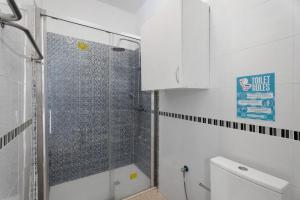 a shower with a glass door in a bathroom at Apartamentos Playa Azul - 8 in Vallehermoso +17 photos
