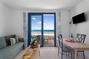 a living room with a couch and a table with a view of the ocean at Apartamentos Playa Azul - 8 in Vallehermoso