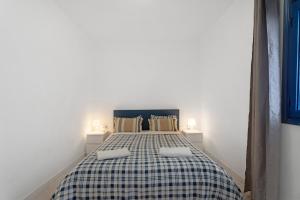 a bedroom with a bed with two pillows on it at Apartamentos Playa Azul - 8 in Vallehermoso