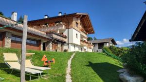 a house on a hill with a bench in the yard at Waldes Duft Apartment - Patleidhof in Naturno
