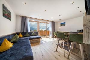 a living room with a couch and a table at Waldes Duft Apartment - Patleidhof in Naturno