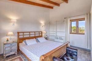 a bedroom with a wooden bed and a window at Villa Gemma in Ses Salines +19 photos