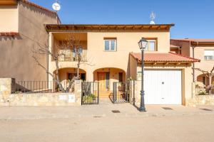 a large house with a white garage door at Torre Piquer in Berge