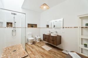 a bathroom with two toilets and a shower at Sunlit Modern Stay in Arona +20 photos