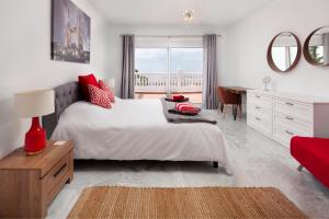 a bedroom with a bed and a desk and a table at Casa Montelado in Mijas +37 photos