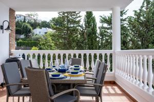 a patio with a table and chairs on a balcony at Casa Montelado in Mijas