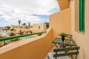 a balcony with a table and a bench on a building at Casa Relax in Costa Calma