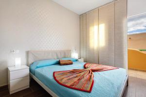 a bedroom with a bed with a scarf on it at Casa Relax in Costa Calma +20 photos