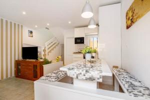 a living room with a table and a television at Casa Relax in Costa Calma
