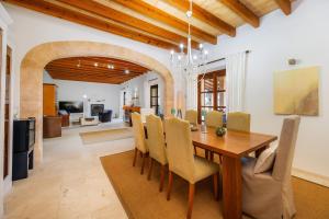 a dining room and living room with a table and chairs at Siesta del Sol in Manacor