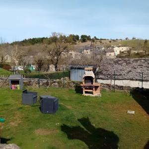 a yard with a building in the grass at Gîte Du Recoux in Le Recoux
