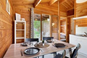 a dining room with a table in a tiny house at Chalet confort 18 in Saint-Gervais