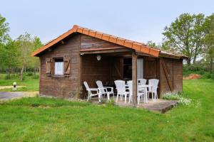 a wooden cabin with chairs and a table in it at Chalet confort 18 in Saint-Gervais