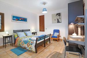 a bedroom with a bed and a desk in it at La Escuelita in Los Valles
