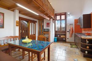 a kitchen with a table in the middle of a room at La Escuelita in Los Valles