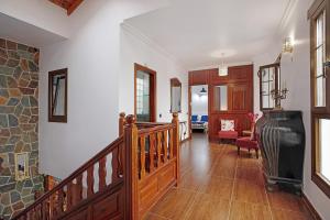 a hallway with a staircase and a living room at La Escuelita in Los Valles