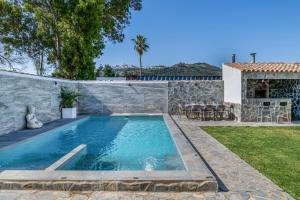 a swimming pool in the backyard of a house at Casa El Buda in Vejer de la Frontera