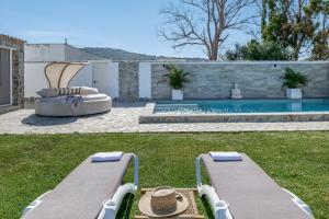 a backyard with two beds and a swimming pool at Casa El Buda in Vejer de la Frontera