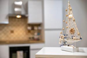 a miniature christmas tree on a counter in a kitchen at L'Angolo Monolocale- Porto Torres in Porto Torres